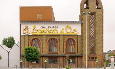 Izegem, De gerestaureerde schoenfabriek met in de gevelfries het opschrift Eperon d’Or en de wapenschilden van België en Luxemburg in ververst bladgoud